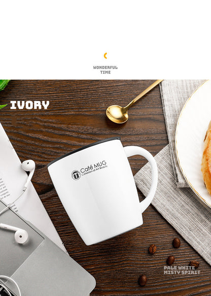 White mug with 'Cafe Mug' branding on a wooden table with coffee beans and a spoon.