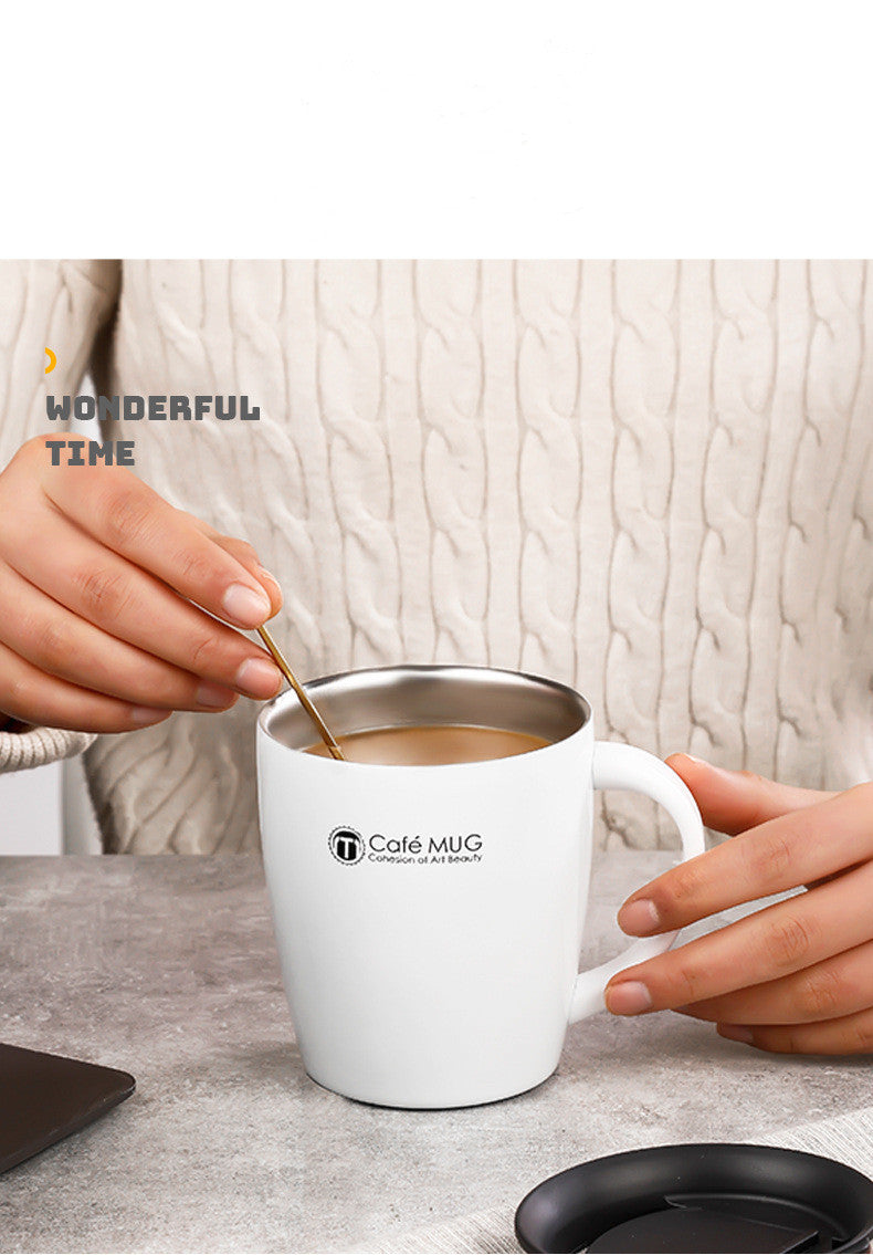 Person stirring a coffee mug labeled 'Café MUG' with a spoon on a light background.