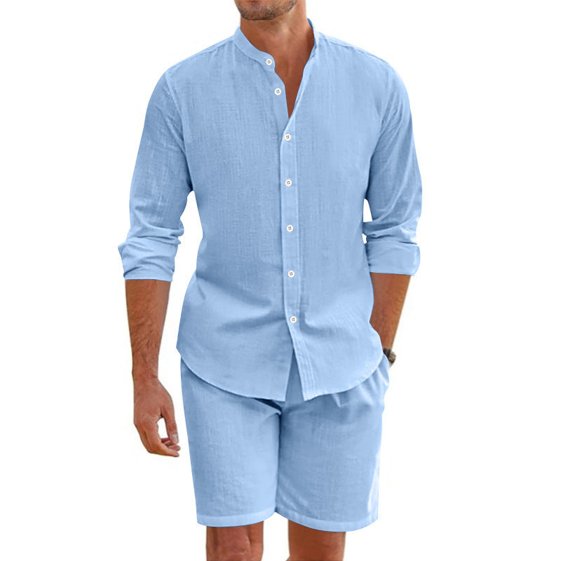 Man wearing a light blue button-up shirt and shorts set on a white background