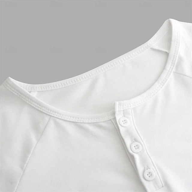 Close-up of a white shirt with button details on a gray background