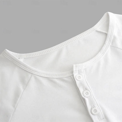 Close-up of a white shirt with button details on a gray background