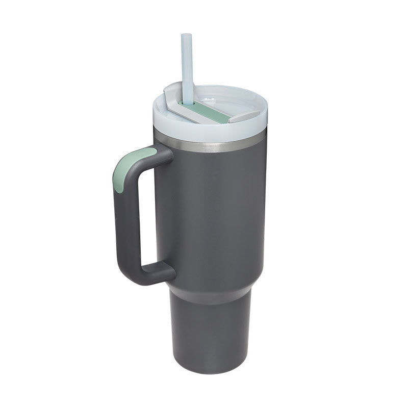Gray travel mug with handle and straw lid on a white background