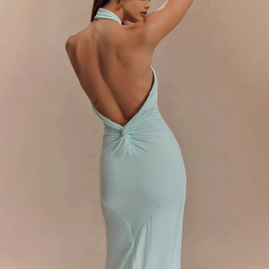 Mint green evening gown with a deep neckline on a beige background